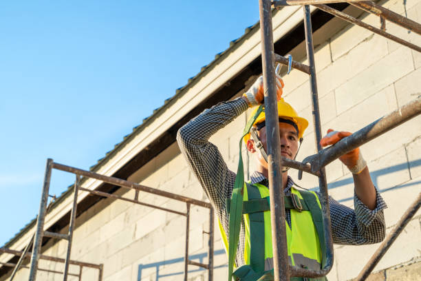 istock Construction workers in uniform and safety equipment working at building site. 1299210497