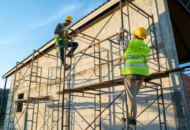 istock Construction workers in uniform and safety equipment working on scaffolding. 1299210503