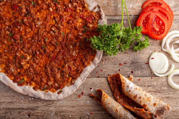 istock Traditional Turkish Pizza known as Lahmacun made with thin flat dough covered with mixture containing ground beef and baked in stone oven 1299212288