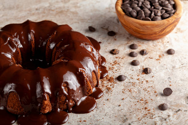 istock Angled view of a chocolate bundt cake with chocolate pudding icing dripping on top of it. 1299212289
