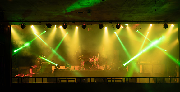 shot showing drum kit with multiple drums cymbals snares bass and more placed on a stage ready for a performance concert gig at a night club pub cafe in Gurgaon Delhi mumbai