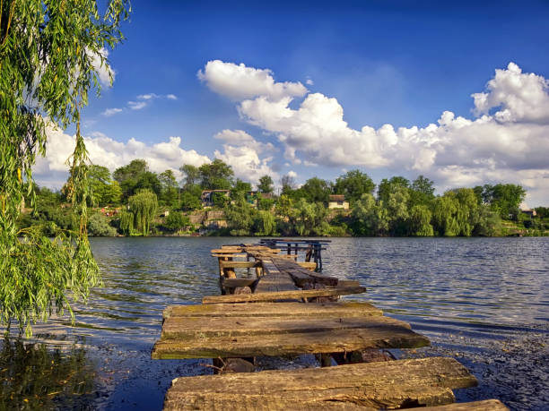 istock Summer landscape and wooden destroyed bridge 1299215603