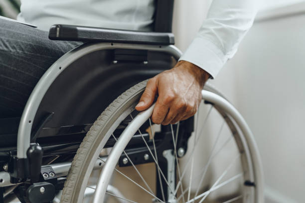 istock Unrecognizable man sitting in wheelchair close up 1299219421
