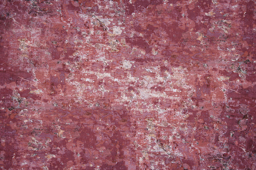 Concrete texture - close-up of a fragment of an old concrete wall with remnants of red paint