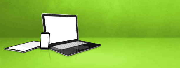 istock Laptop, mobile phone and digital tablet pc on green office desk. Banner background 1299222198