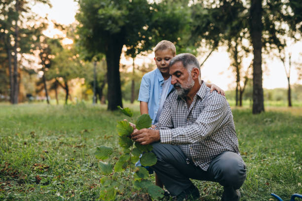 istock grandfather and grandson in public park 1299222454