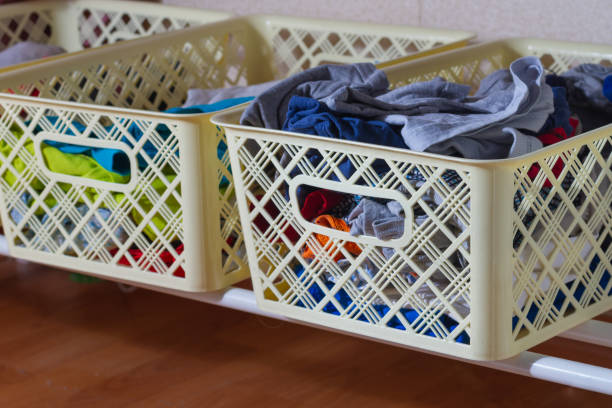 istock Boxes of unfolded clothes are on the shelf 1299224418