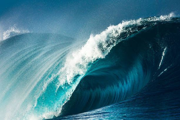 istock Powerful blue and aquamarine wave breaking in the open ocean on a sunny day 1299225208