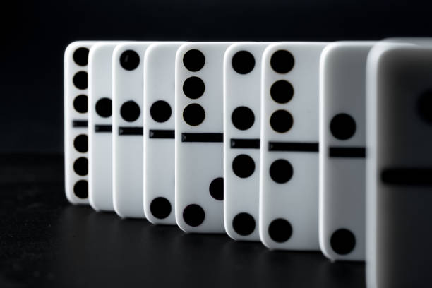 istock Domino pieces put in a row on black background 1299225739