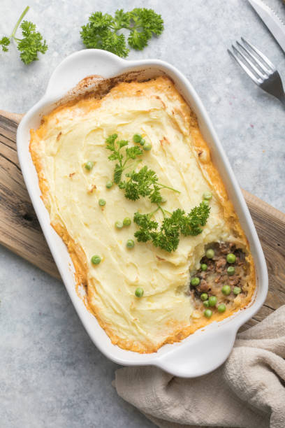 istock Shepherd's Pie with ground beef, potato and cheese on wooden background, top view, copy space. Traditional homemade Irish casserole 1299226458