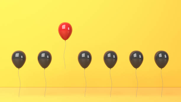 istock Standing out from the crowd and different concept, red and black balloon on yellow background 1299226763