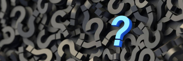 istock Blue question mark on a background of black signs, FAQ Concept 1299226880