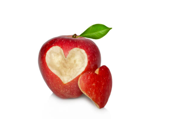 istock Red apple with heart symbol isolated 1299227565