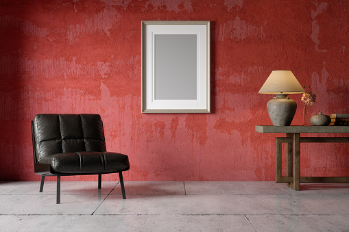 Interior Of Living Room With Black Armchair, Lamp Shade,Tiled Floor And Empty Frame On Red Wall Background.