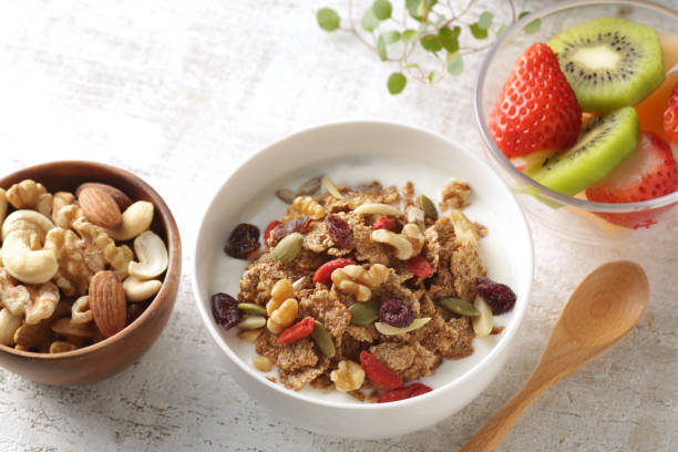 istock Breakfast of yogurt-poured cereal, fruits and nuts 1299228837