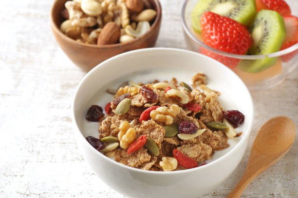 istock Breakfast of yogurt-poured cereal, fruits and nuts 1299228842