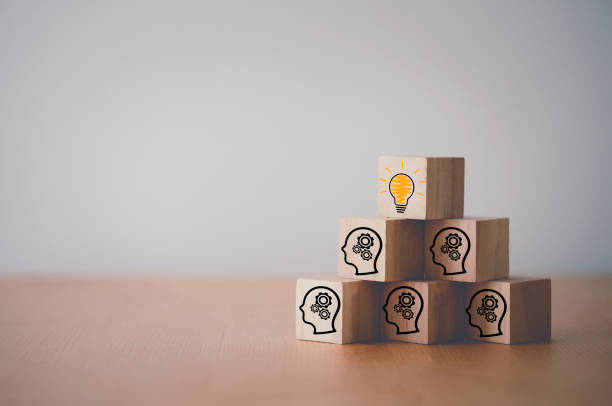 istock Wooden cube block which print screen lightbulb icon on face with gear, creative idea and innovation concept. 1299230709