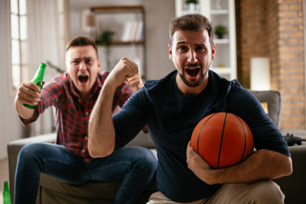 istock Men drinking beer and watching sports game on tv. 1299231763