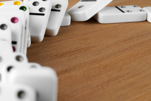 istock White domino dice on a wooden table 1299231922