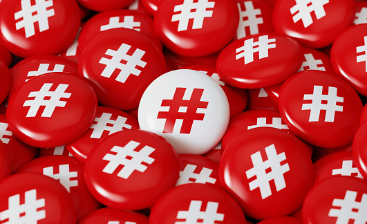 Group of hashtag symbol printed badges in red and white. Great use for online messaging and social media concepts. Horizontal composition with copy space.