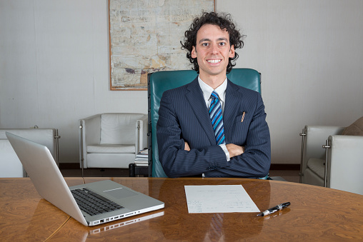 young businessman in his office using laptop