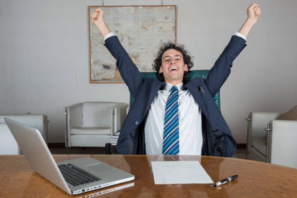 istock young businessman in his office happy for a success 1299232614