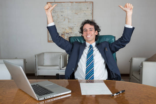 istock young businessman in his office happy for a success 1299233170