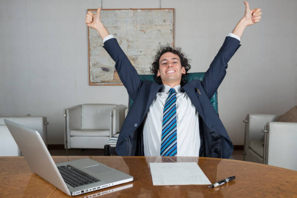 istock young businessman in his office happy for a success 1299233264