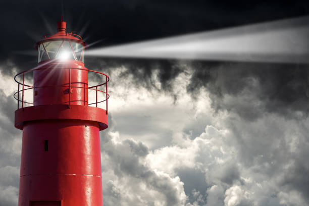istock Old Red Lighthouse with Storm Clouds on the Background - Bad weather 1299234802