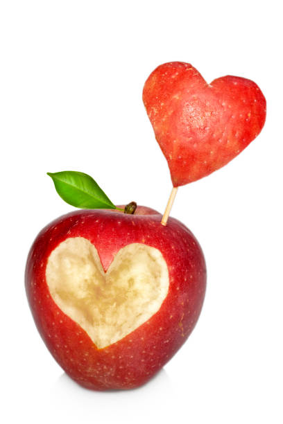 istock Red apple with heart symbol isolated 1299237742