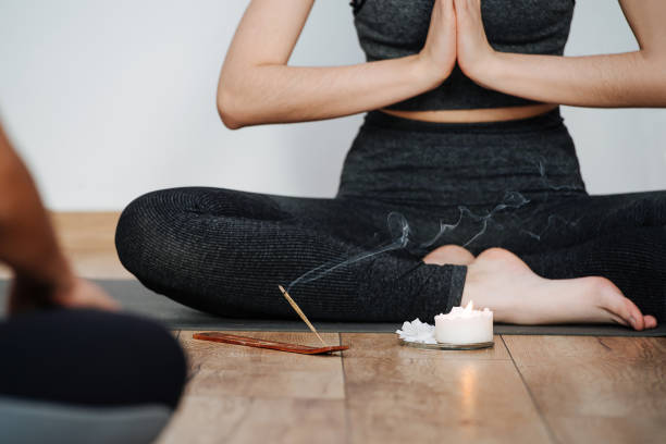 istock Cropped image of female instructor practicing yoga, meditating with joined hands 1299237884