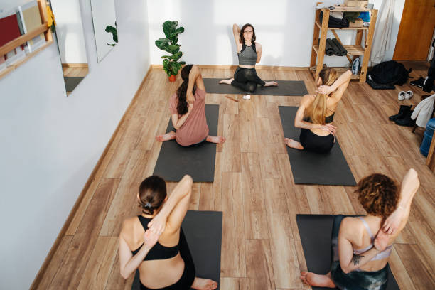 istock High angle image of women practicing yoga, connecting fingers behind their backs 1299237912