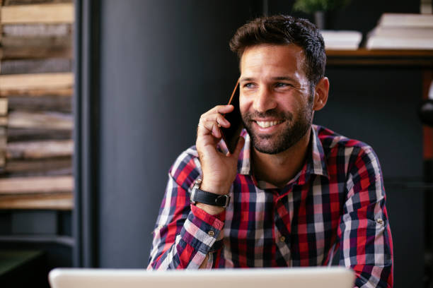 istock Smiling businessman talking to the phone. 1299238126