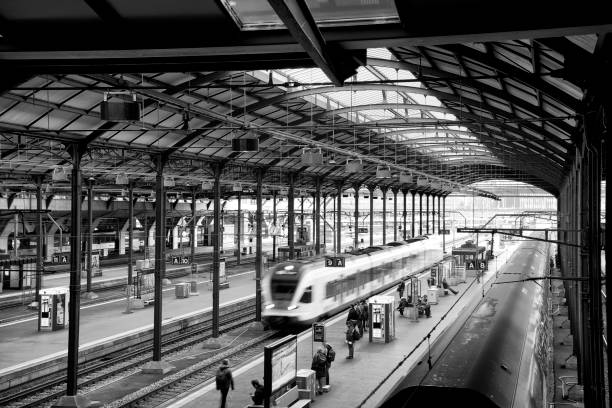 Modern high speed train in motion on railway station. Lucerne, Switzerland, February 21st 2017: People waiting for departure in railway station. Lucerne railway station is a major hub of the rail network of Switzerland. train station black and white stock pictures, royalty-free photos & images