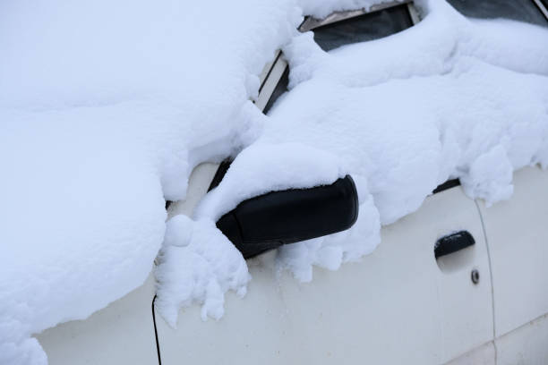 istock Car covered with snow in the parking after a snow storm 1299238760
