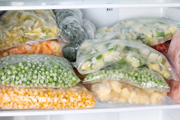 istock Plastic bags with deep frozen vegetables in refrigerator, horizontal 1299239483