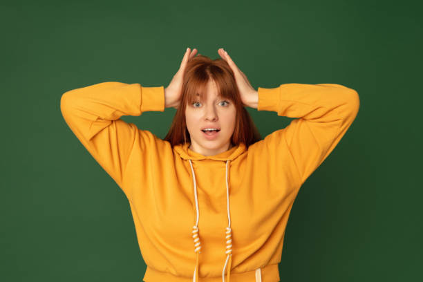 istock Caucasian woman's portrait isolated on green studio background with copyspace 1299241746