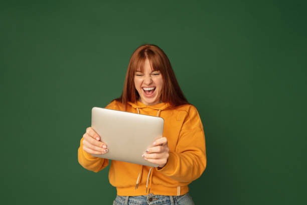 Caucasian woman's portrait isolated on green studio background with copyspace