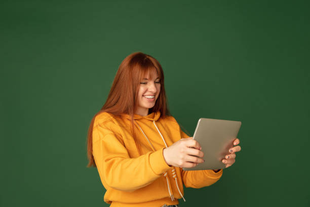 istock Caucasian woman's portrait isolated on green studio background with copyspace 1299241802