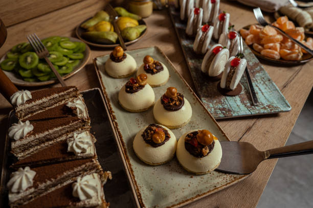 istock Sweet table with variation of cakes in restaurant 1299242139