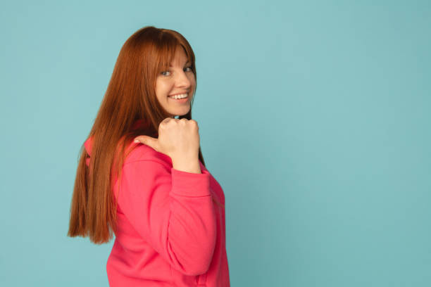 istock Caucasian woman's portrait isolated on blue studio background with copyspace 1299242959