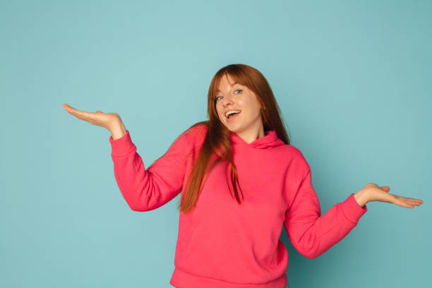 istock Caucasian woman's portrait isolated on blue studio background with copyspace 1299243027