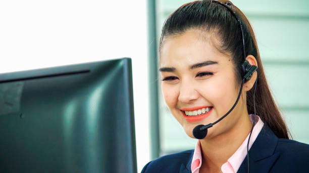 istock Business people wearing headset working in office 1299243303