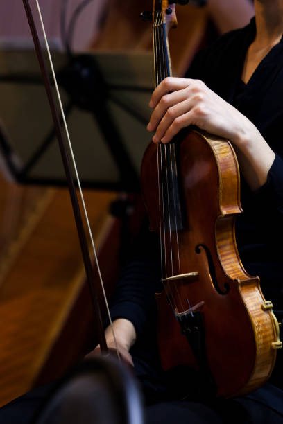 istock Violin in the hands of a musician 1299244256