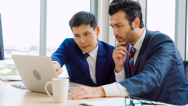 istock Two business people talk project strategy at office 1299244504