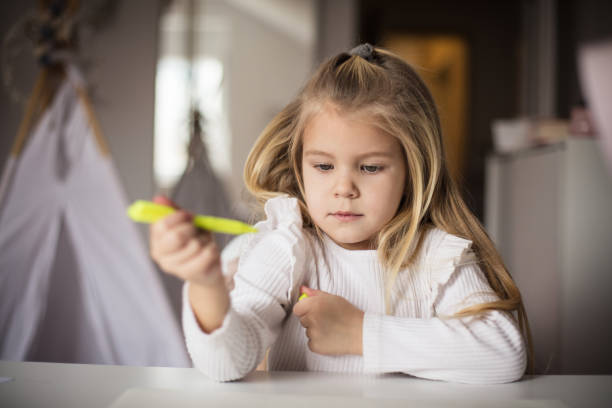 istock Little girl drawing in her room. 1299244557
