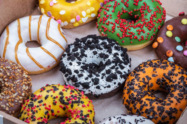 istock donuts with different flavors of glaze in a cardboard box 1299244664
