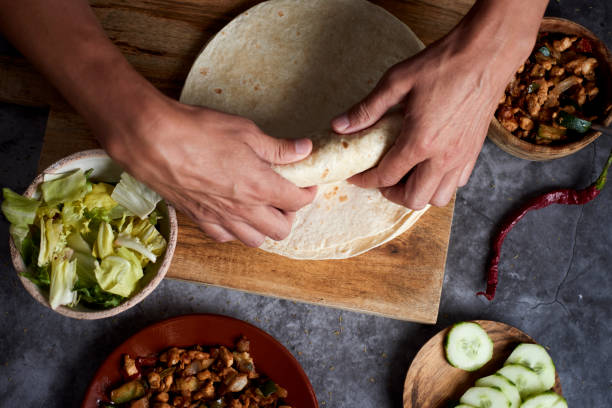 istock young man rolls a durum or a burrito 1299246128