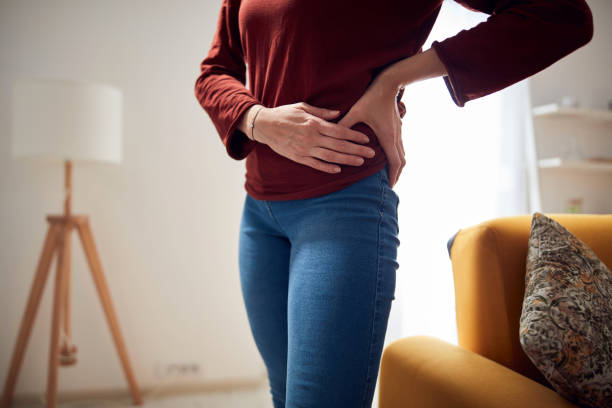 istock Woman with strong hip pain at home. 1299246172