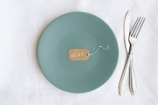istock A label with the text diet on a plate and cutlery 1299246423